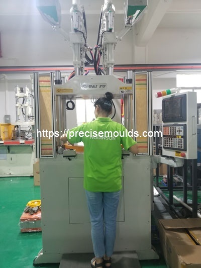 Vertical insert injection molding